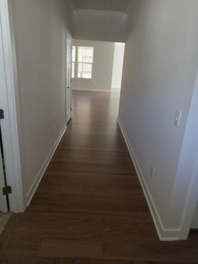 Recoated engineered hardwood running down a hallway