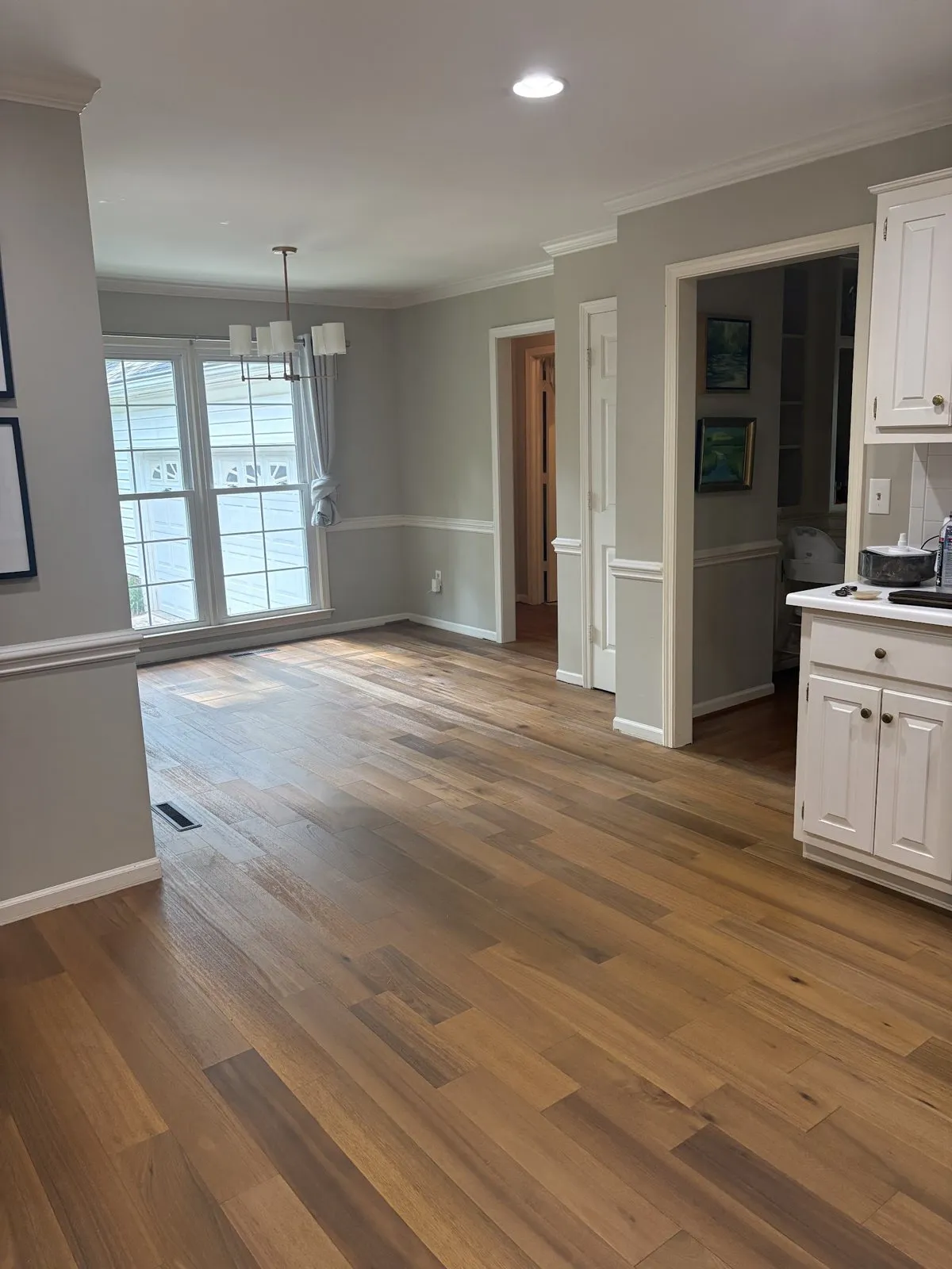 Wood-look plank flooring through an open living and dining area